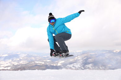 Photo of Male snowboarders on snowy hill. Winter vacation