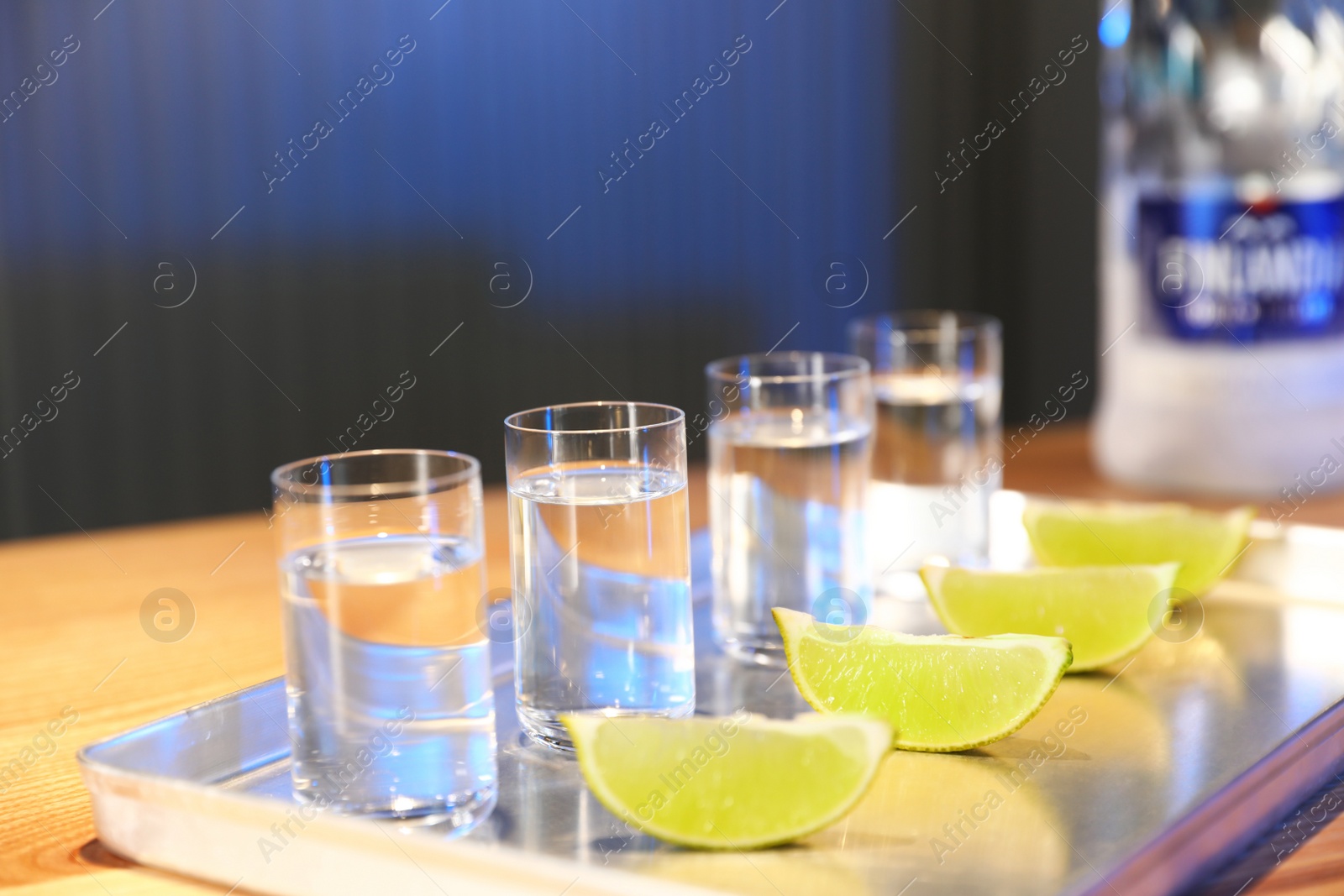 Photo of MYKOLAIV, UKRAINE - SEPTEMBER 23, 2019: Finlandia vodka and lime slices on bar counter