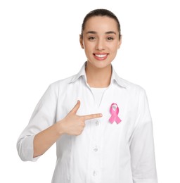 Photo of Mammologist pointing at pink ribbon on white background. Breast cancer awareness