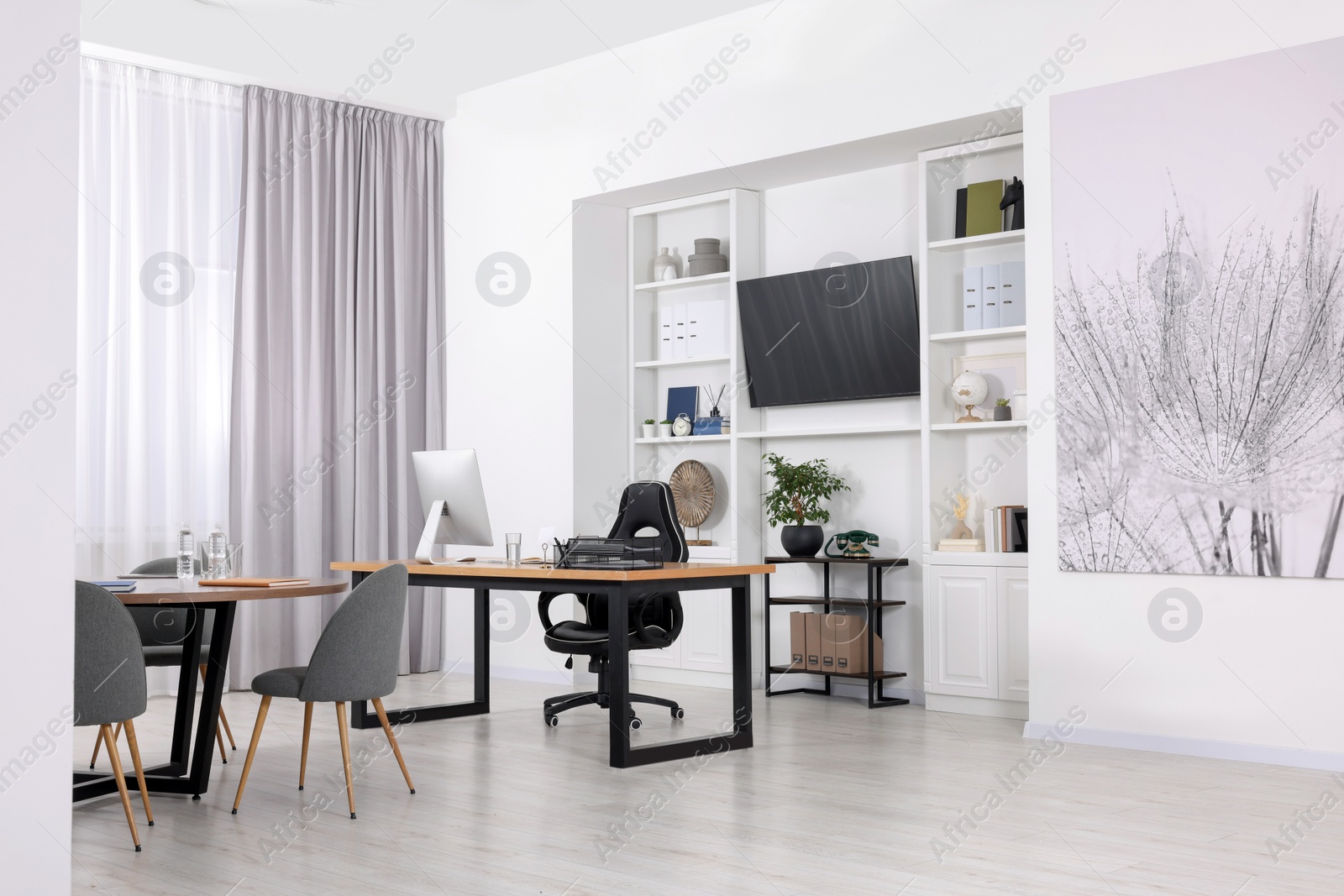 Photo of Stylish office with comfortable furniture and tv zone. Interior design