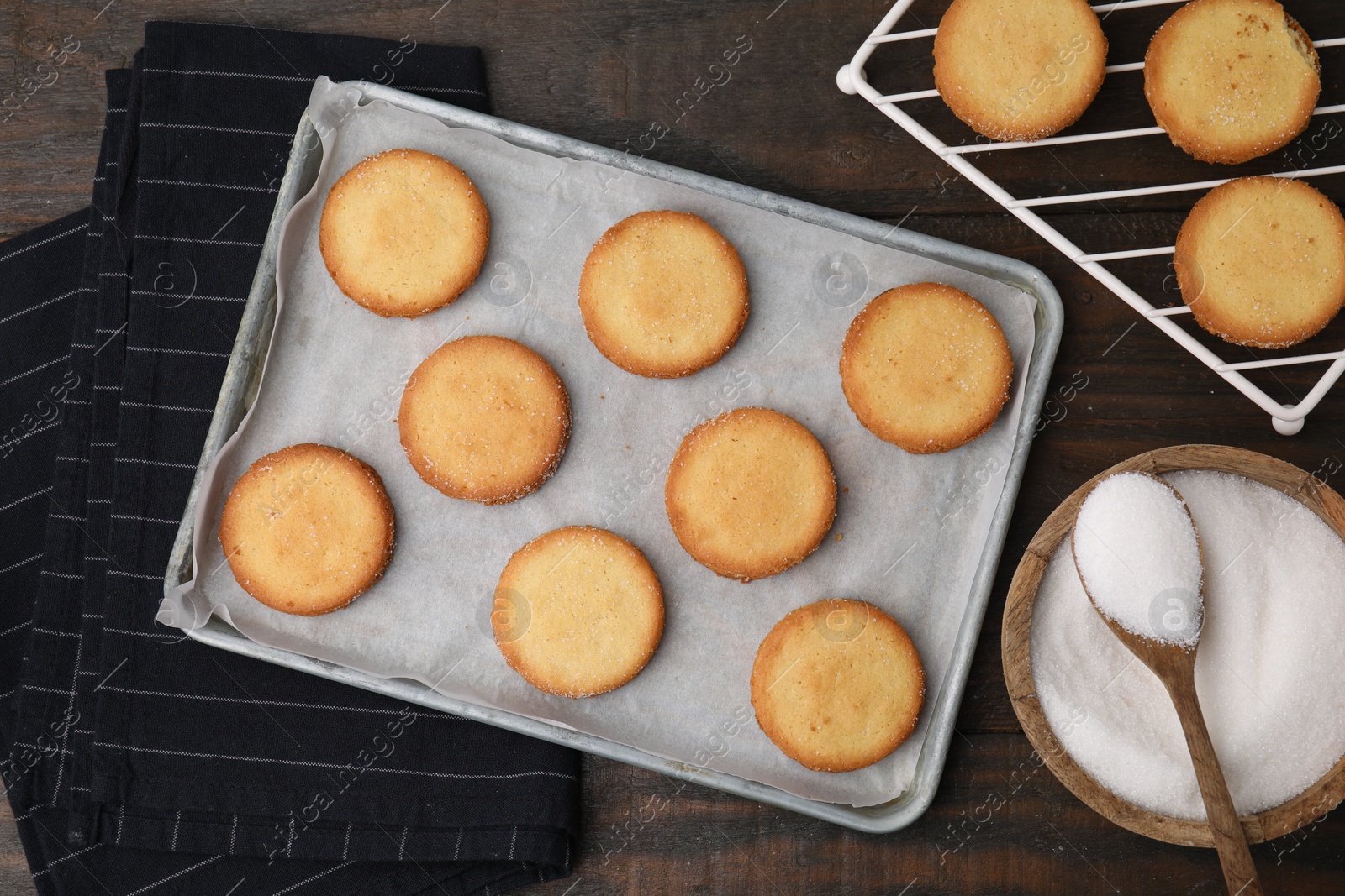 Photo of Tasty sweet sugar cookies on wooden table, flat lay