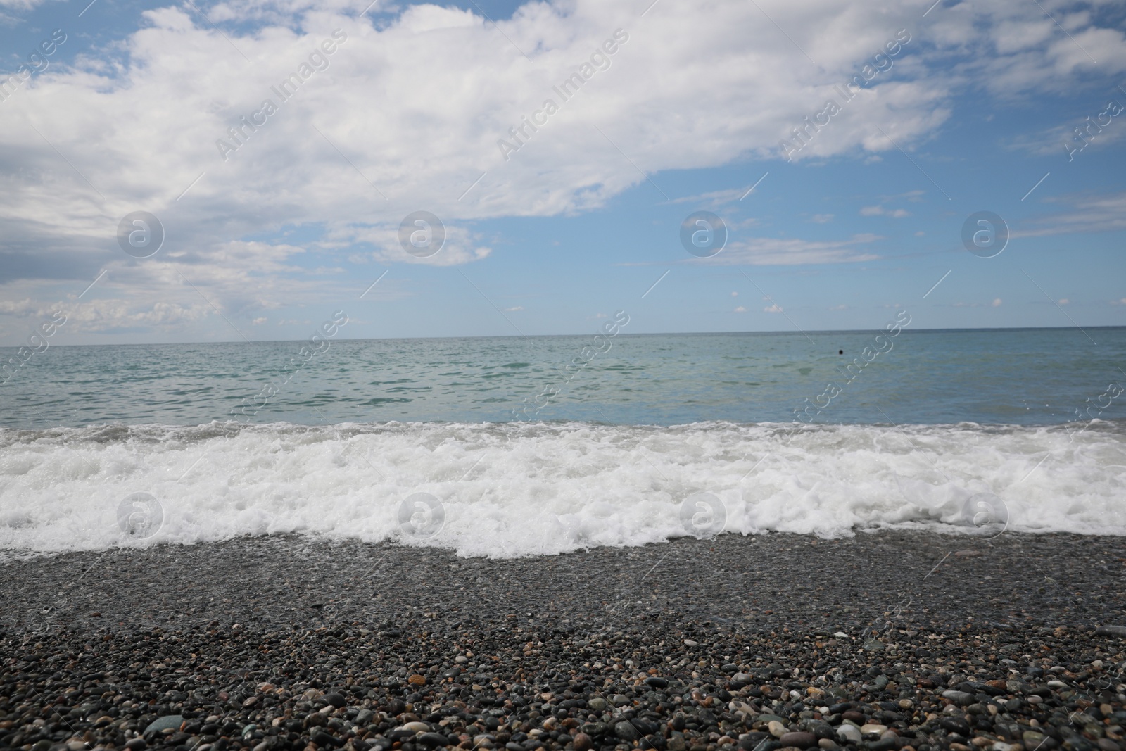 Photo of Picturesque view of beautiful sea shore under sky with fluffy clouds