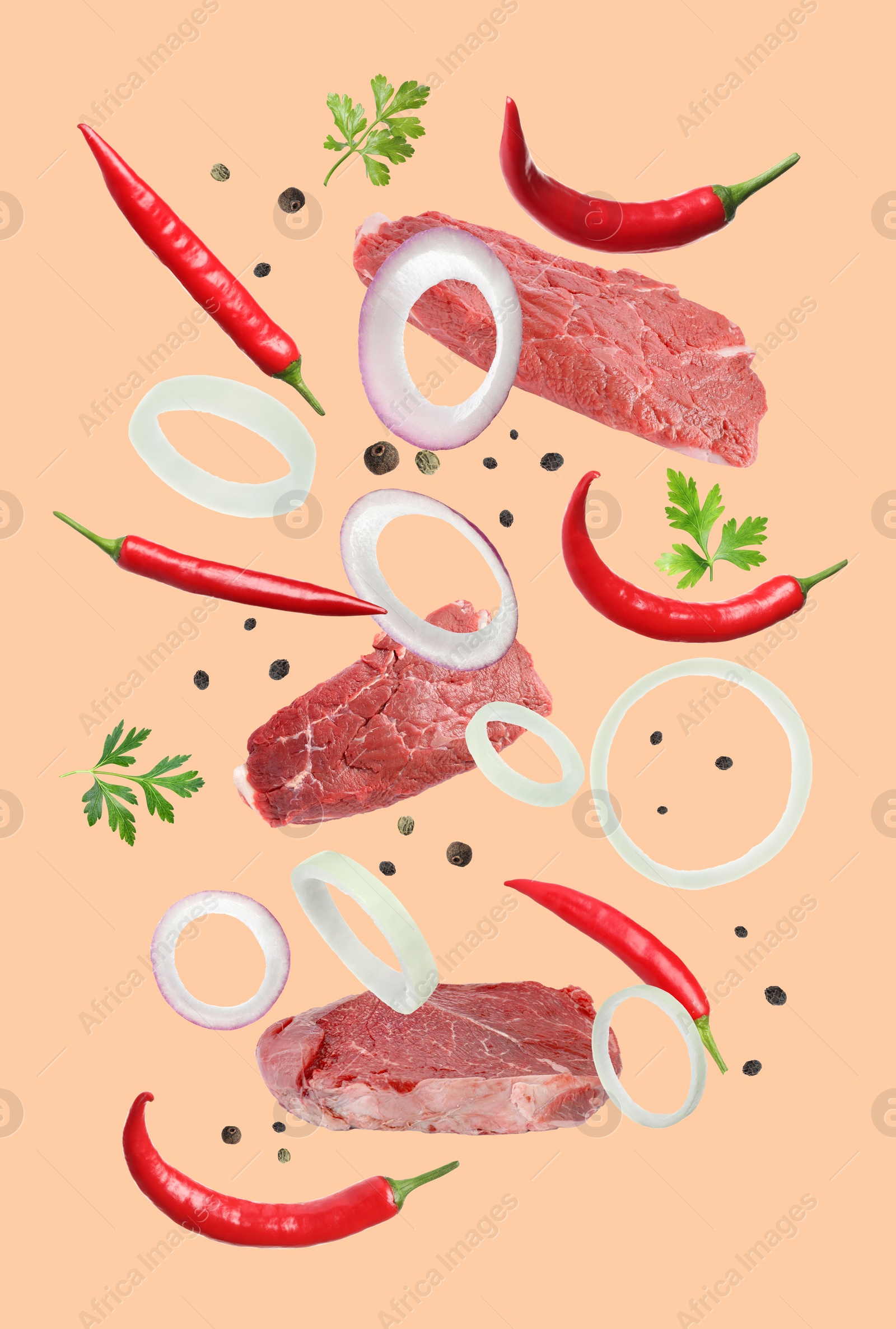 Image of Beef meat and different spices falling on beige background