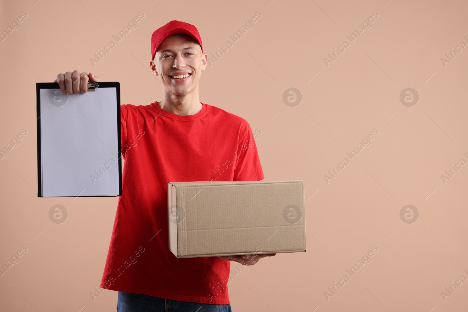 Photo of Happy courier with parcel on beige background. Space for text