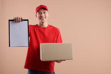 Happy courier with parcel on beige background. Space for text