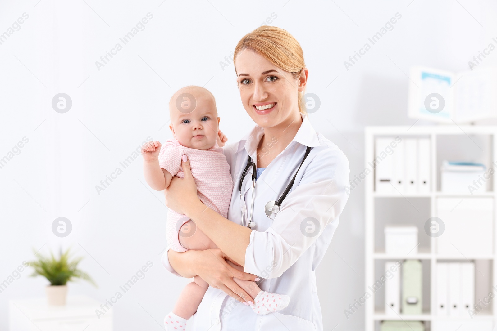 Photo of Children's doctor with cute baby in hospital