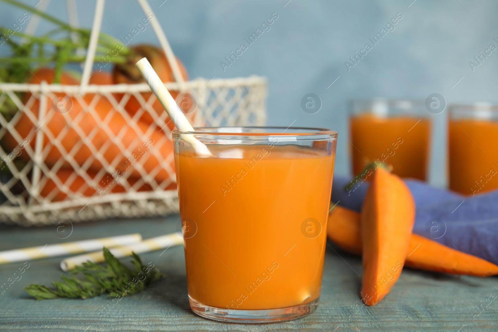 Photo of Freshly made carrot juice on wooden table