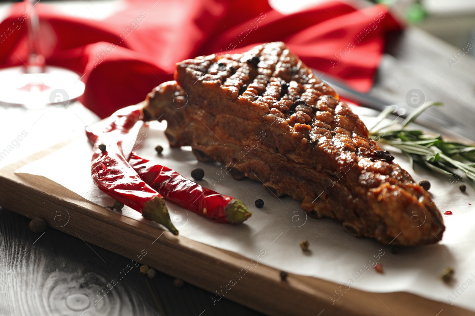 Photo of Delicious roasted ribs served on wooden table