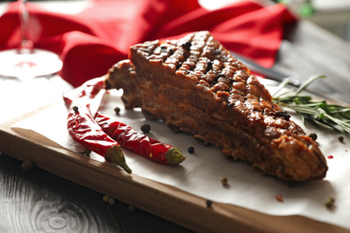 Delicious roasted ribs served on wooden table