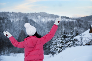 Woman in pink jacket enjoying trip on snowy day