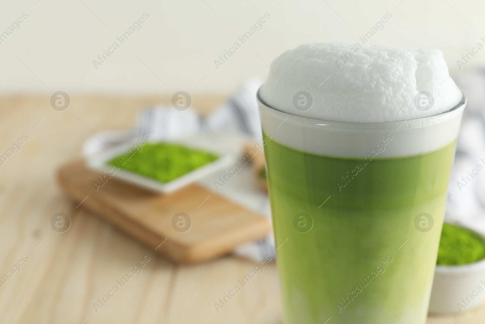 Photo of Glass of fresh matcha latte on table, closeup. Space for text