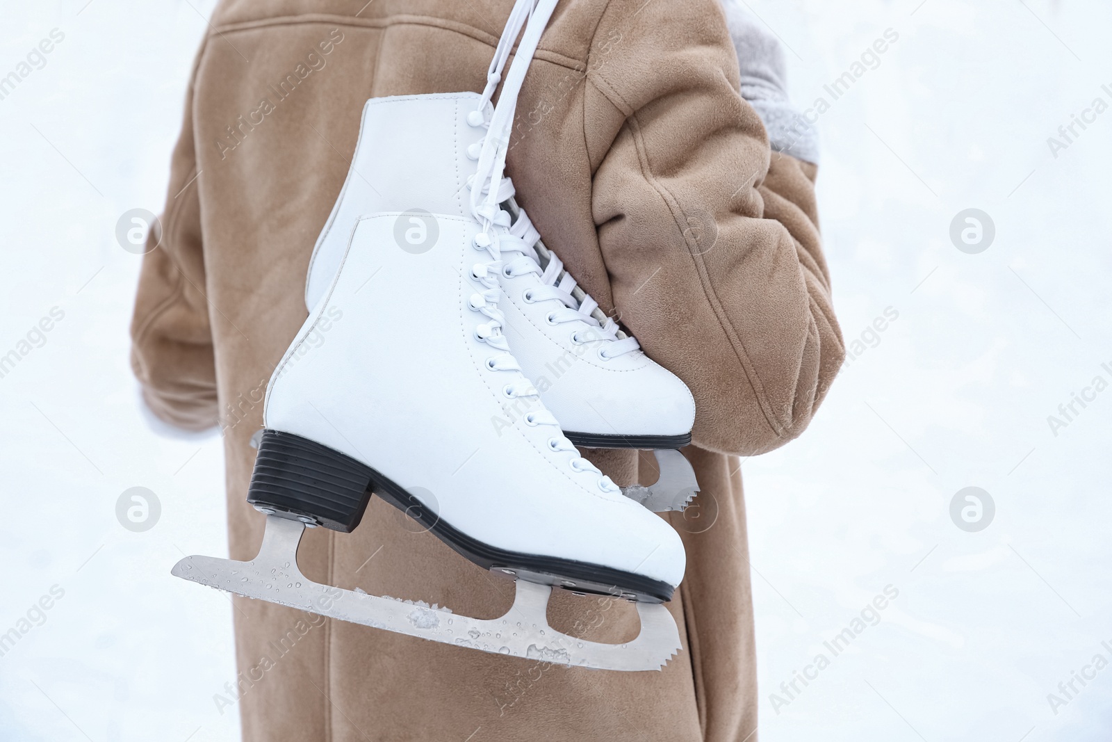 Photo of Woman with figure skates on white background, closeup