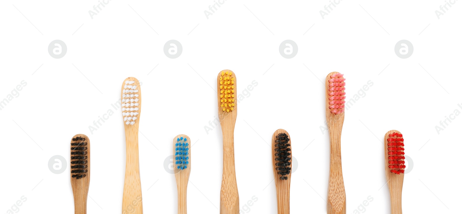 Photo of Bamboo toothbrushes isolated on white, top view