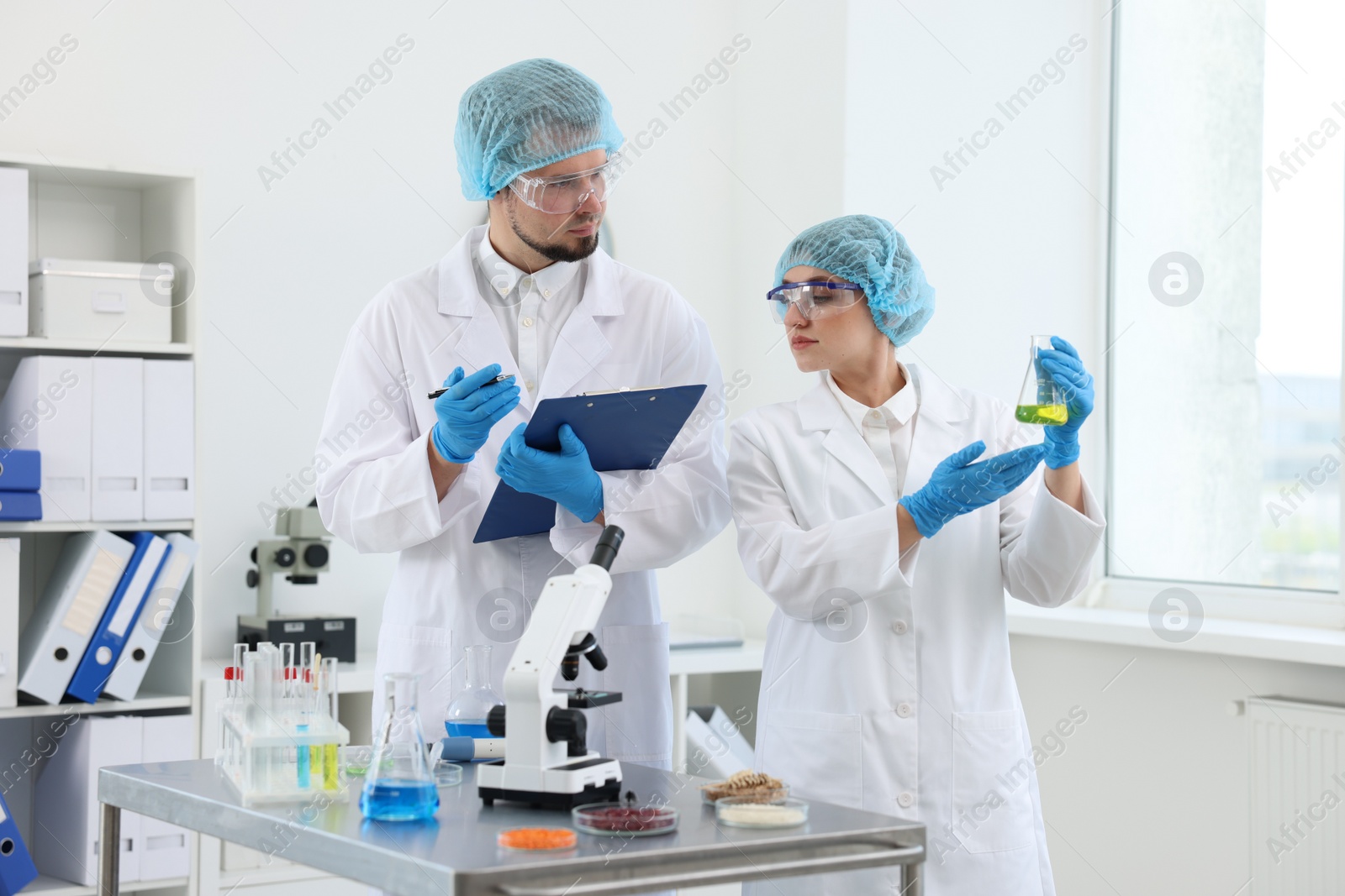 Photo of Quality control. Food inspectors checking safety of products in laboratory