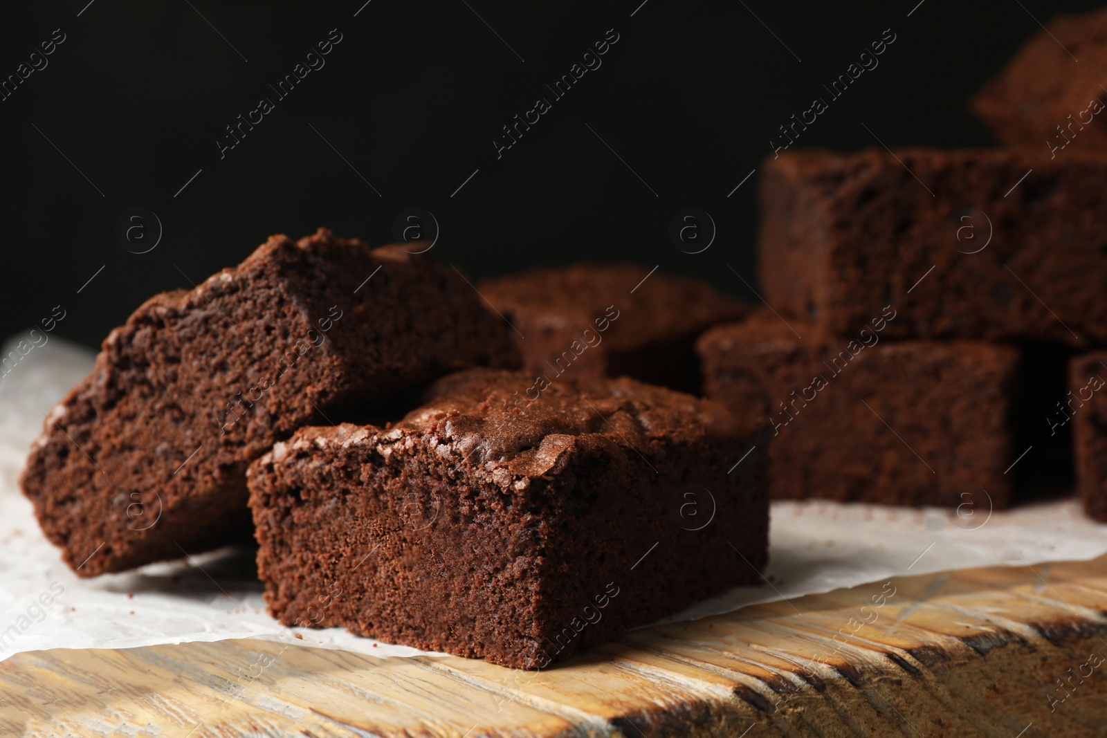 Photo of Fresh brownies on wooden board. Delicious chocolate pie