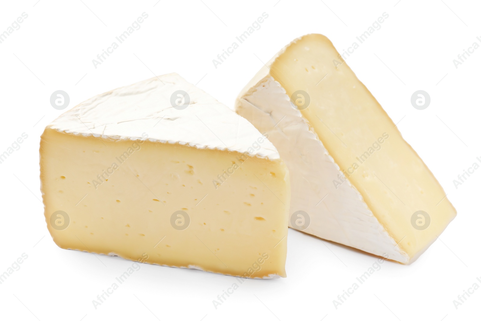 Photo of Pieces of tasty camembert cheese isolated on white