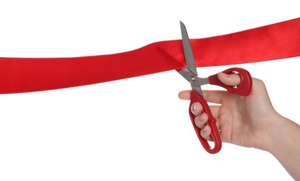 Photo of Woman cutting red ribbon on white background, closeup