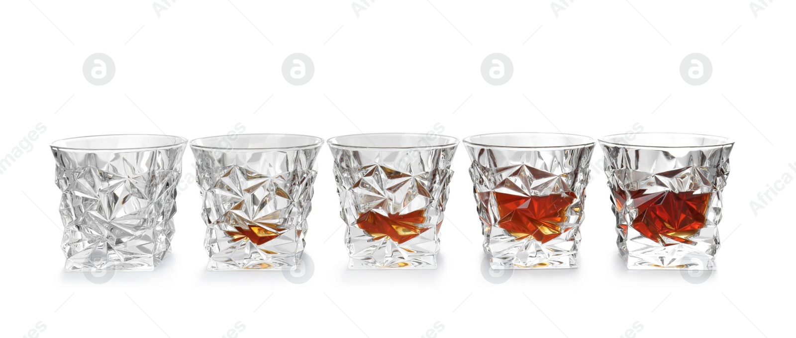 Photo of Empty and full whiskey glasses on white background