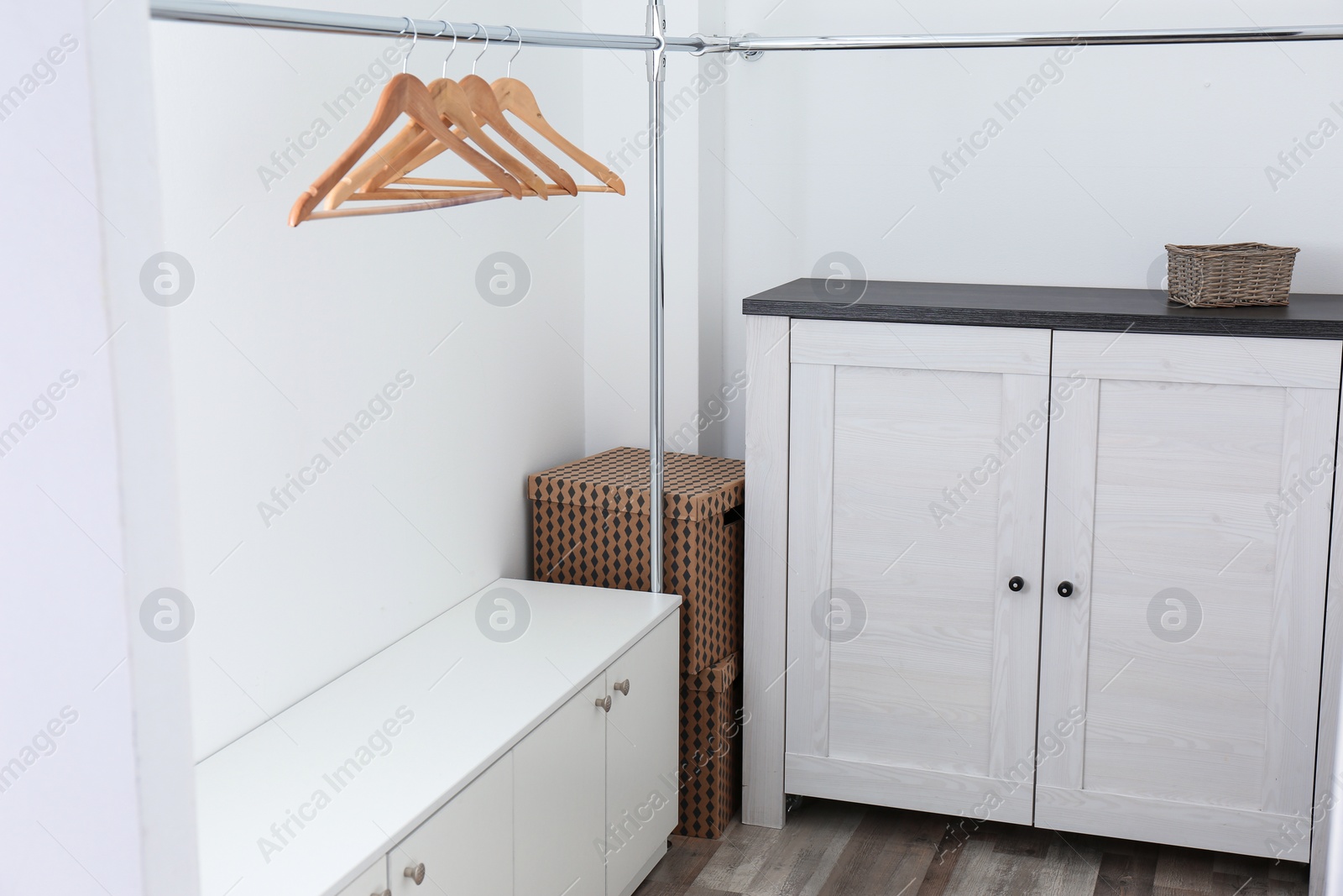 Photo of Modern dressing room interior with furniture and hangers