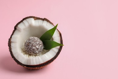 Photo of Delicious vegan candy ball in coconut on pink background. Space for text
