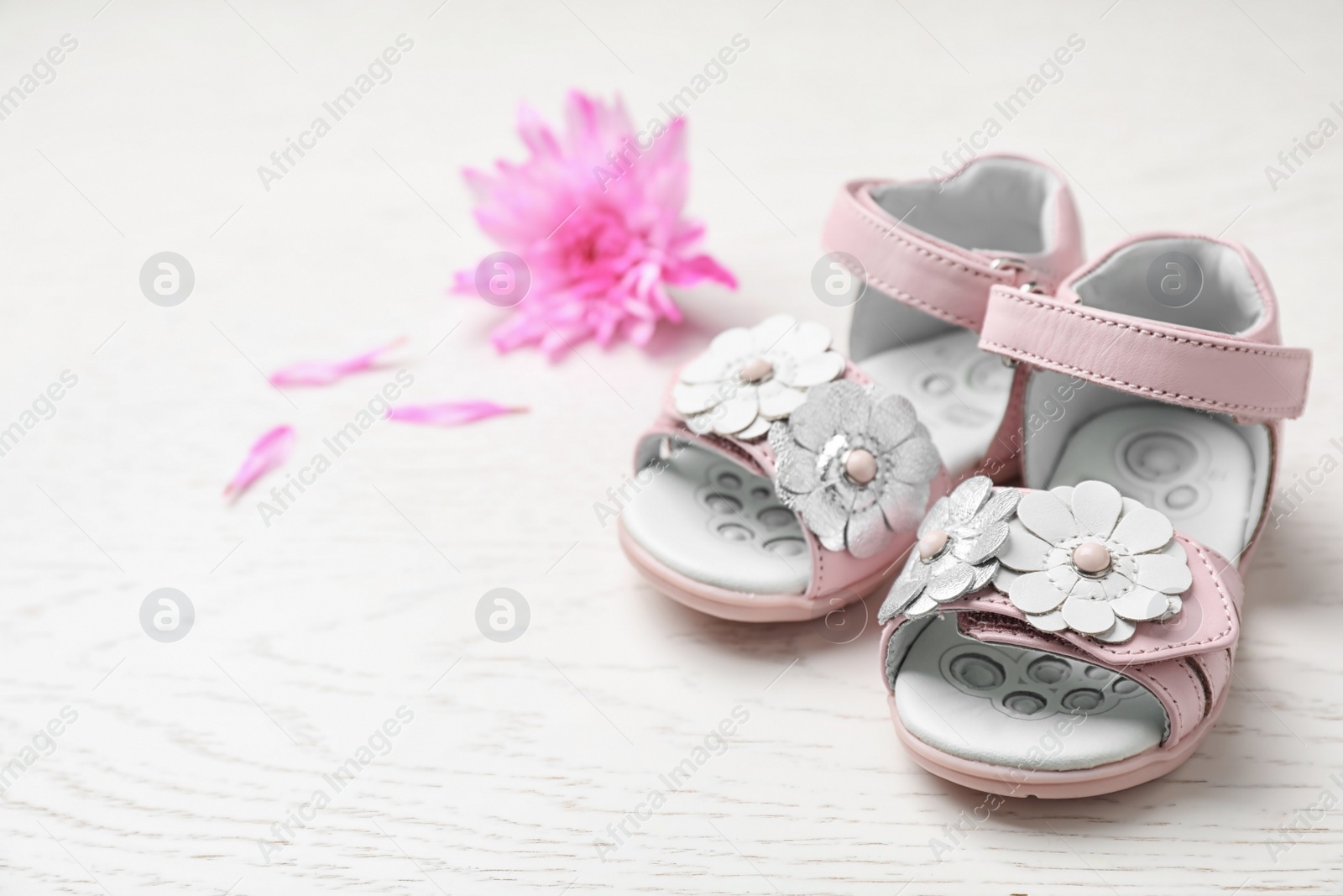 Photo of Pair of cute baby sandals on table