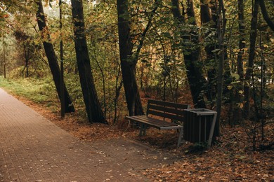 Photo of Many beautiful trees, bench and pathway in autumn park