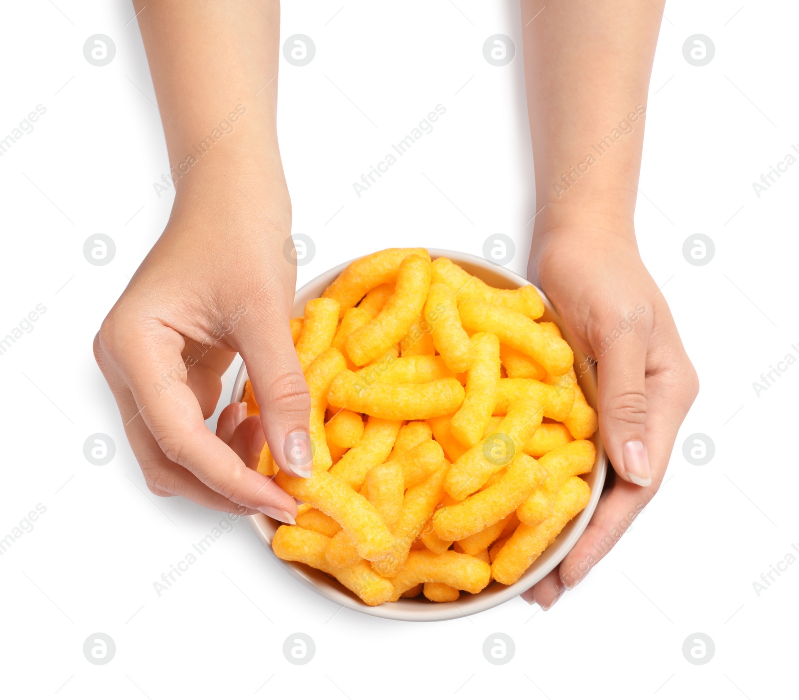 Photo of Woman holding bowl of crunchy cheesy corn sticks on white background, top view