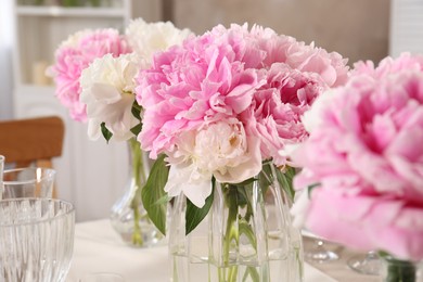 Photo of Stylish table setting with beautiful peonies indoors, closeup