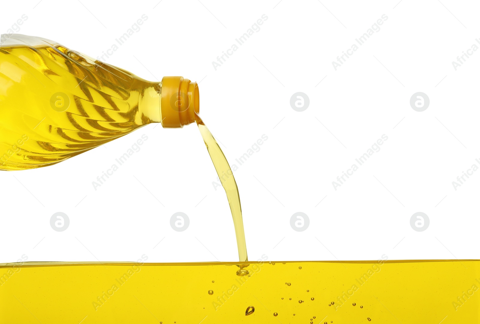 Photo of Pouring cooking oil from bottle on white background