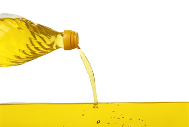 Photo of Pouring cooking oil from bottle on white background