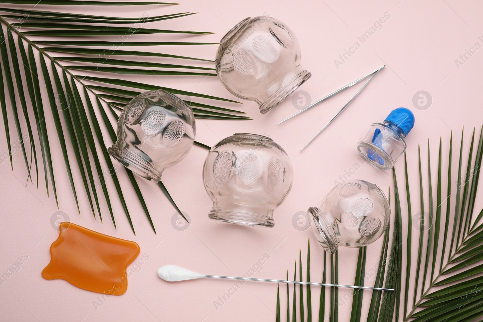 Photo of Flat lay composition with glass cups on pink background. Cupping therapy