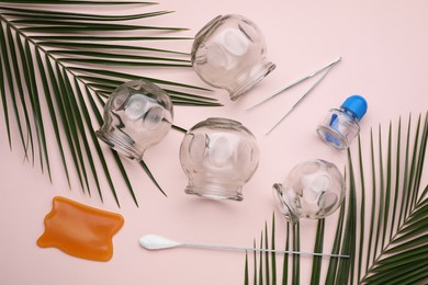 Photo of Flat lay composition with glass cups on pink background. Cupping therapy