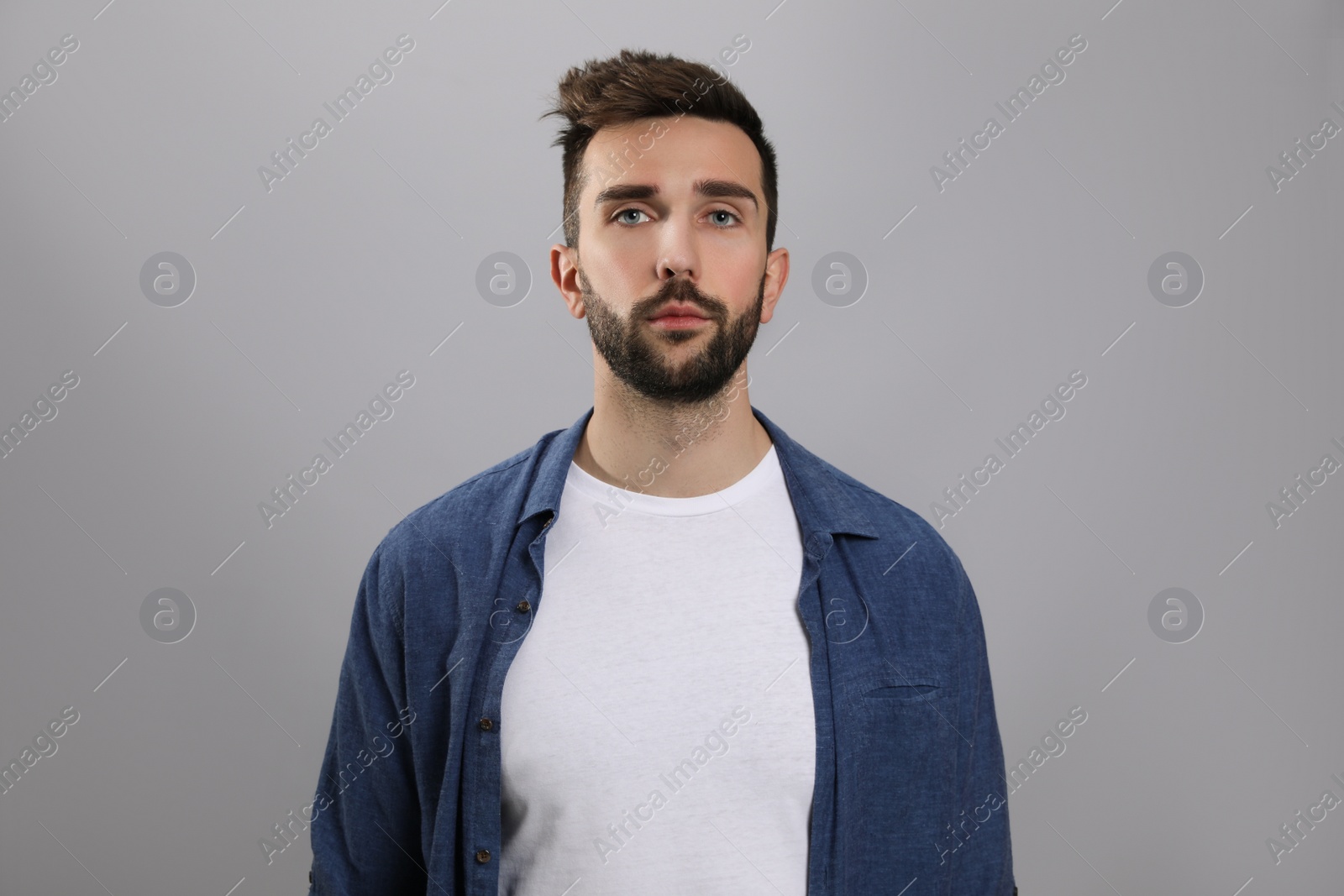 Photo of Portrait of handsome man on grey background