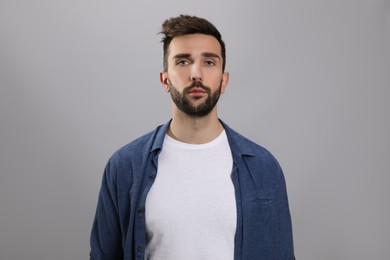 Portrait of handsome man on grey background