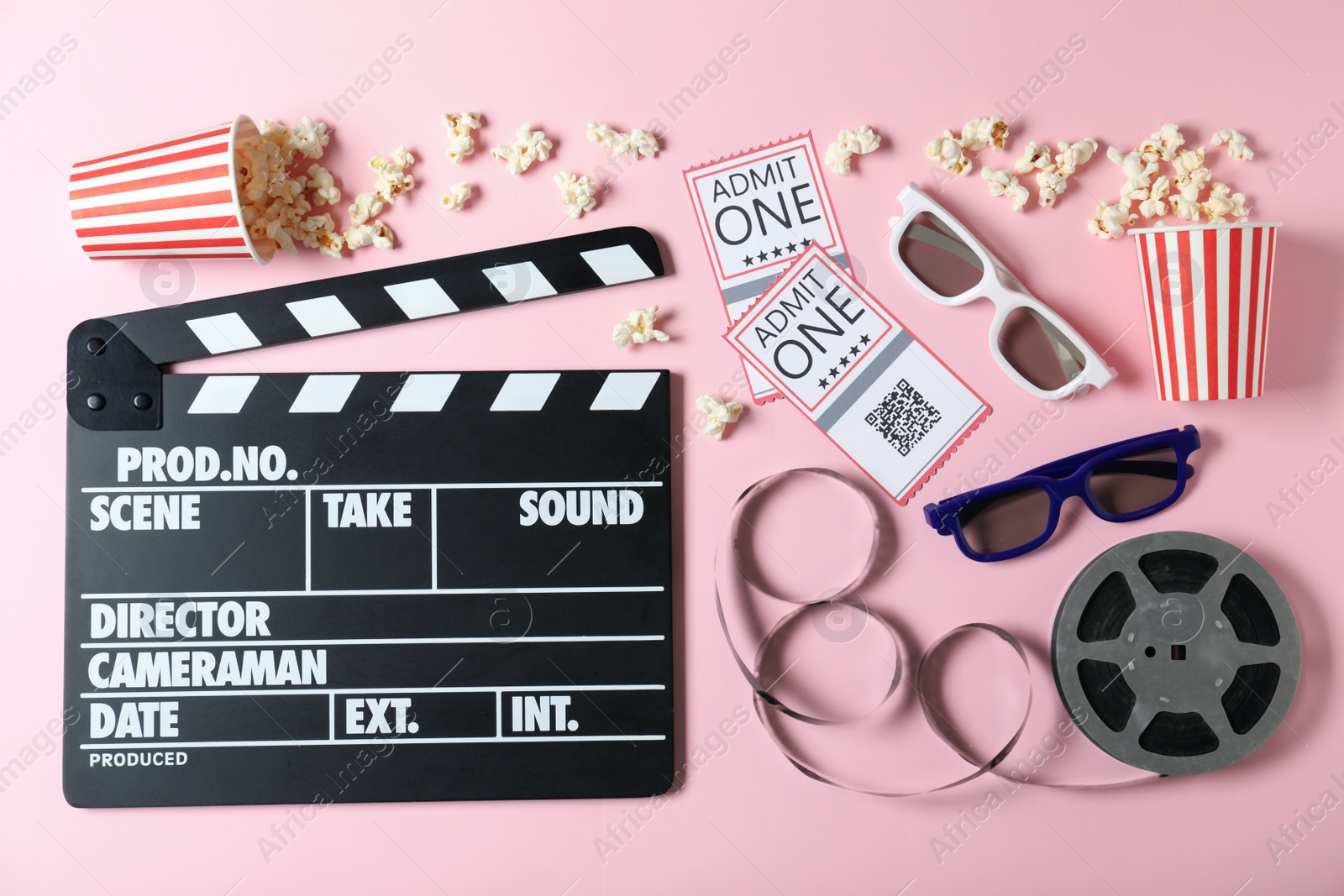 Photo of Flat lay composition with cinema tickets and clapperboard on pink background