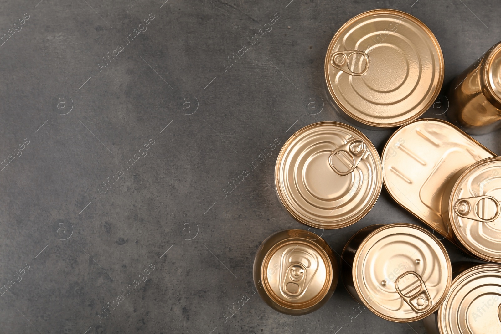 Photo of Many tin cans on grey background, top view. Recycling garbage