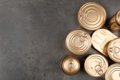 Photo of Many tin cans on grey background, top view. Recycling garbage