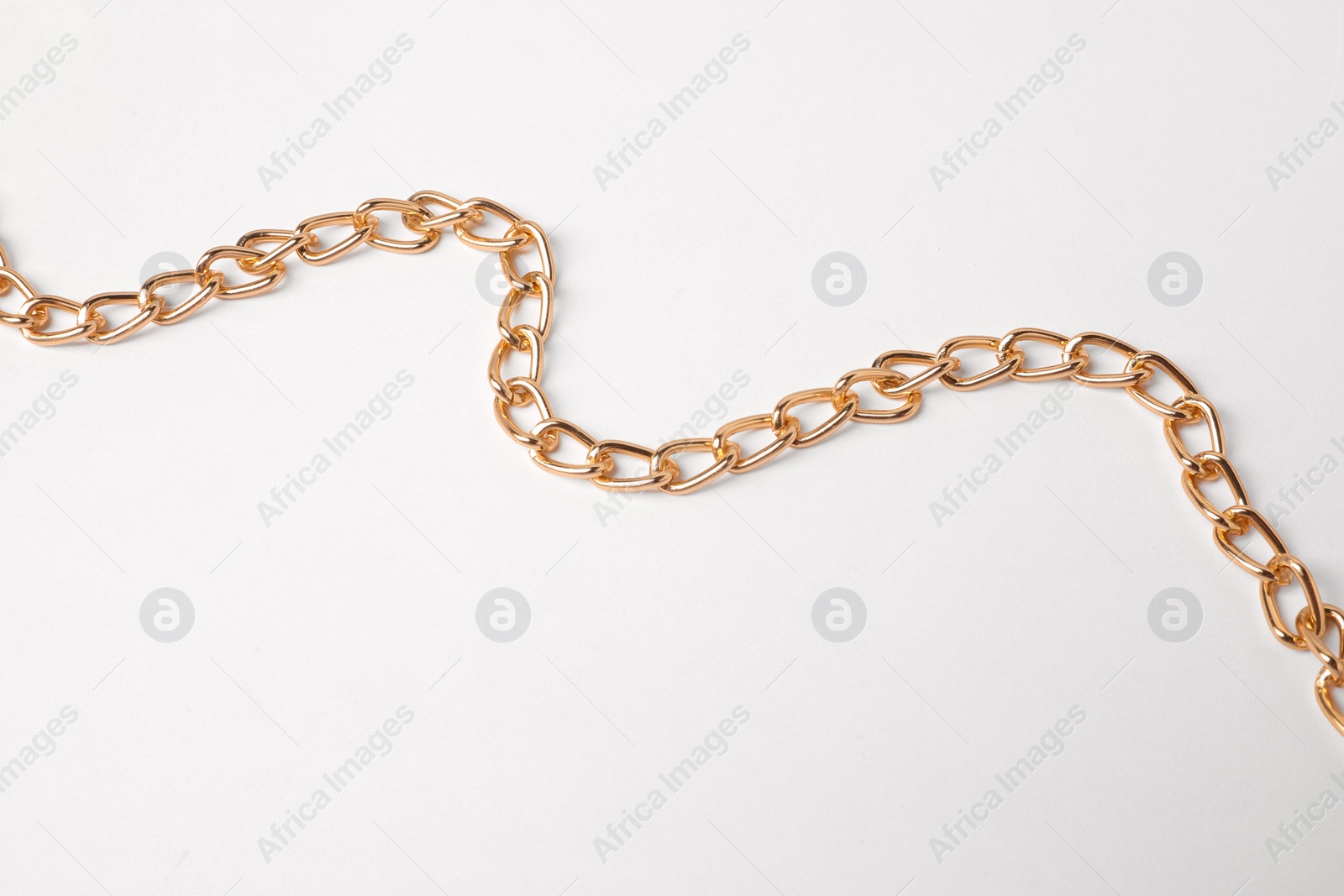 Photo of One metal chain on white background. Luxury jewelry