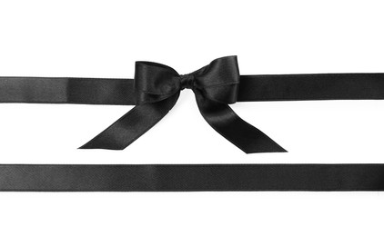 Photo of Black satin ribbons with bow on white background, top view
