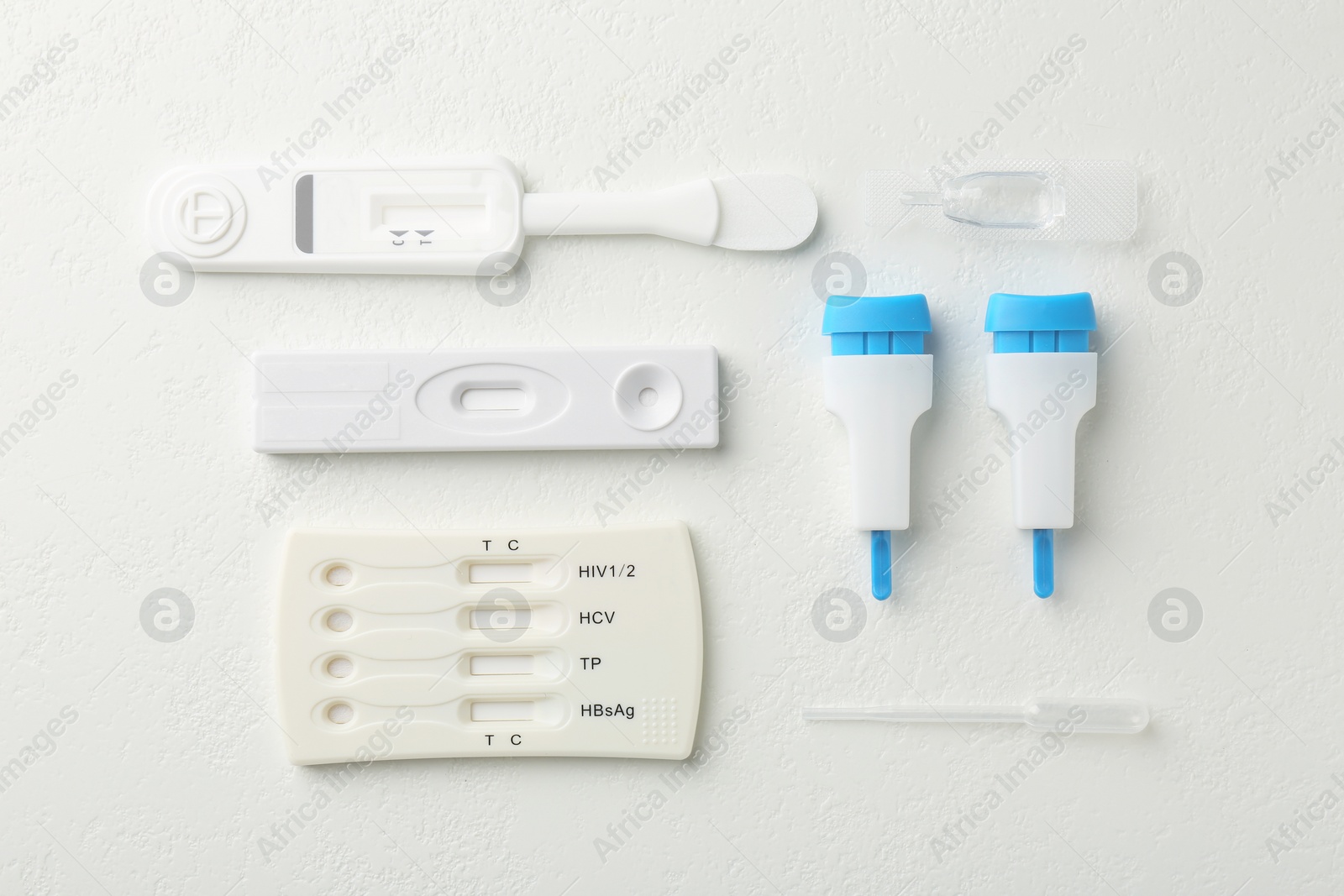 Photo of Disposable express test kits on white table, flat lay