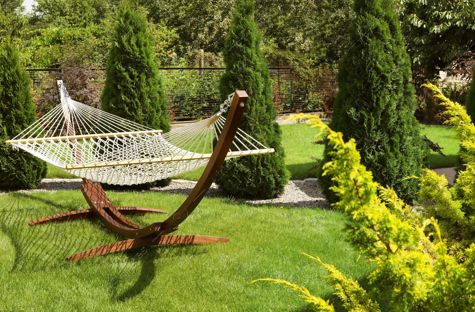 Photo of Empty comfortable hammock outdoors on sunny day