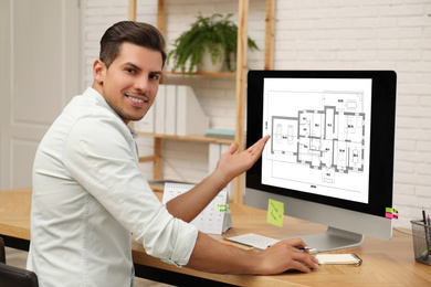 Image of Architect making project of house on computer in office