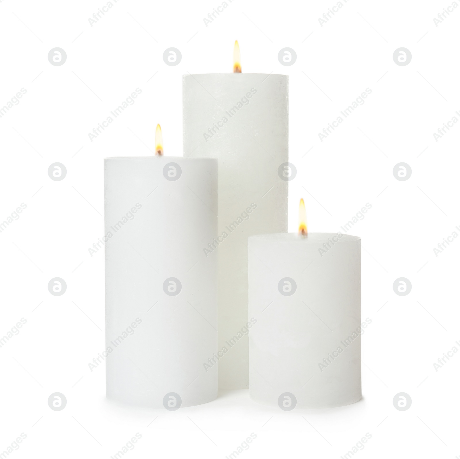 Photo of Three alight wax candles on white background