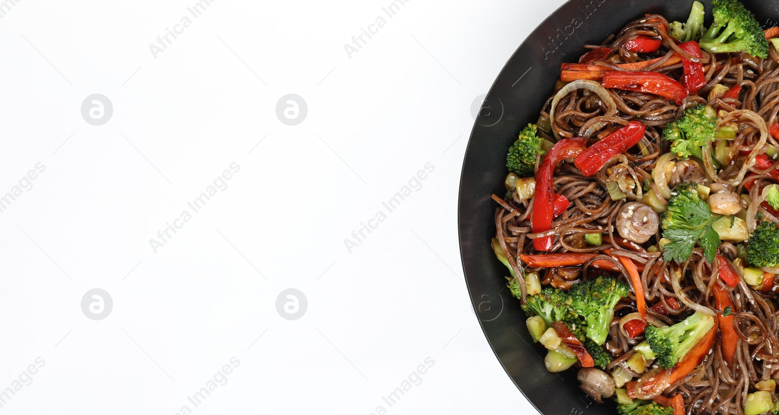 Photo of Stir-fry. Tasty noodles with meat and vegetables in wok on white background, top view. Space for text