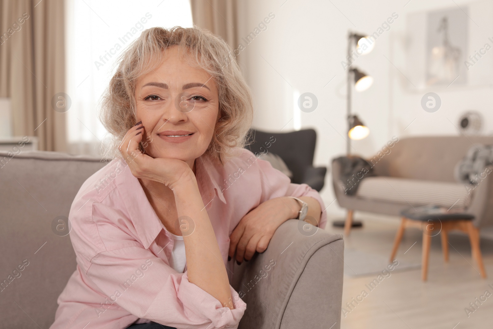 Photo of Portrait of mature woman in living room