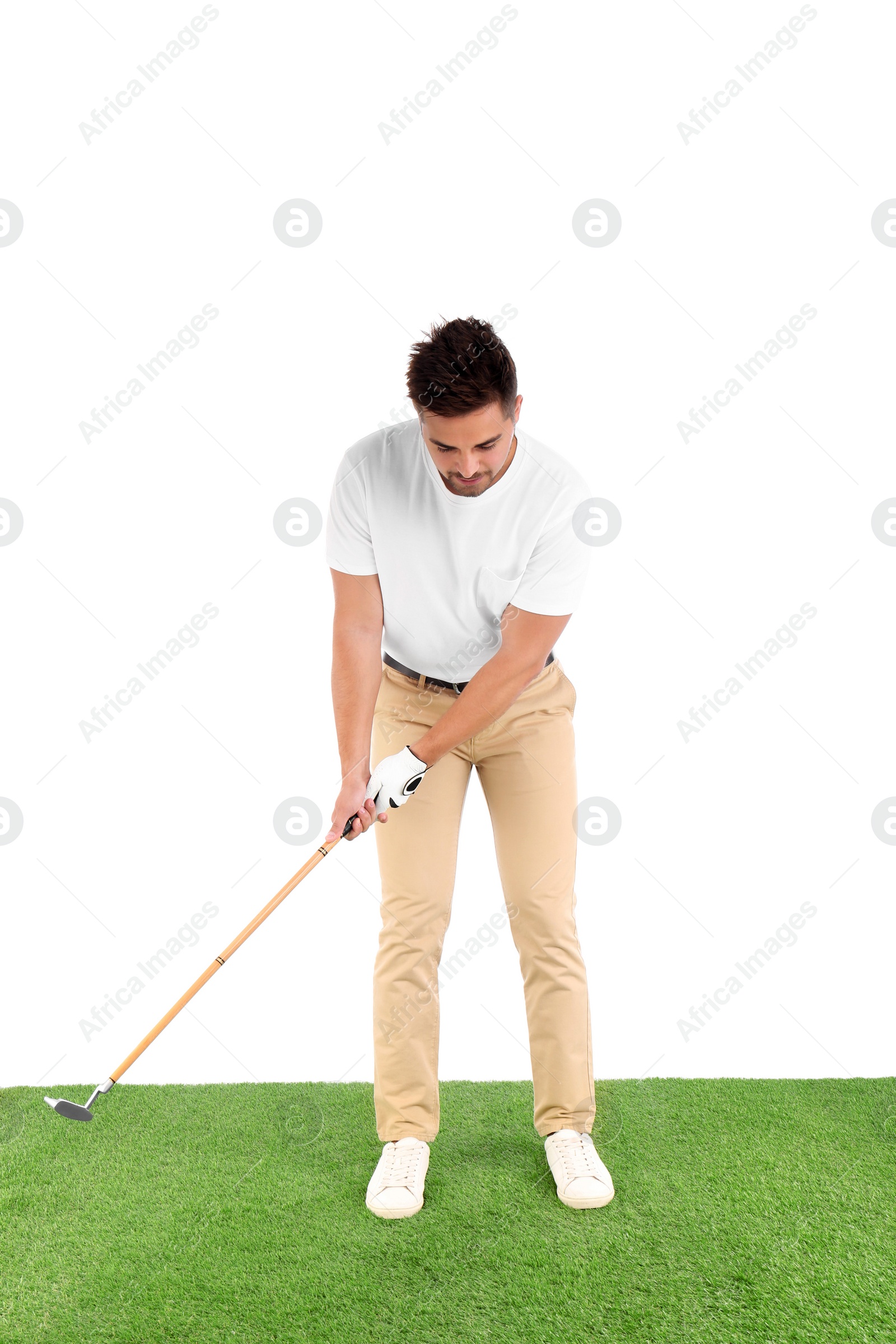 Photo of Young man playing golf on course against white background