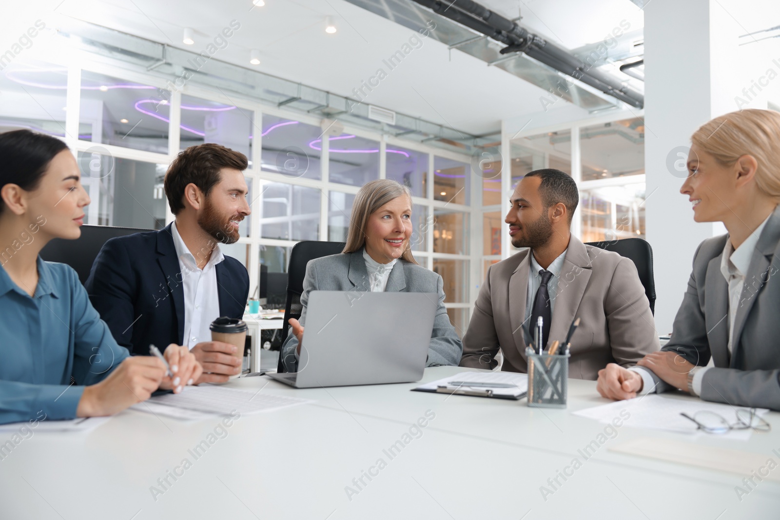 Photo of Lawyers working together at table in office