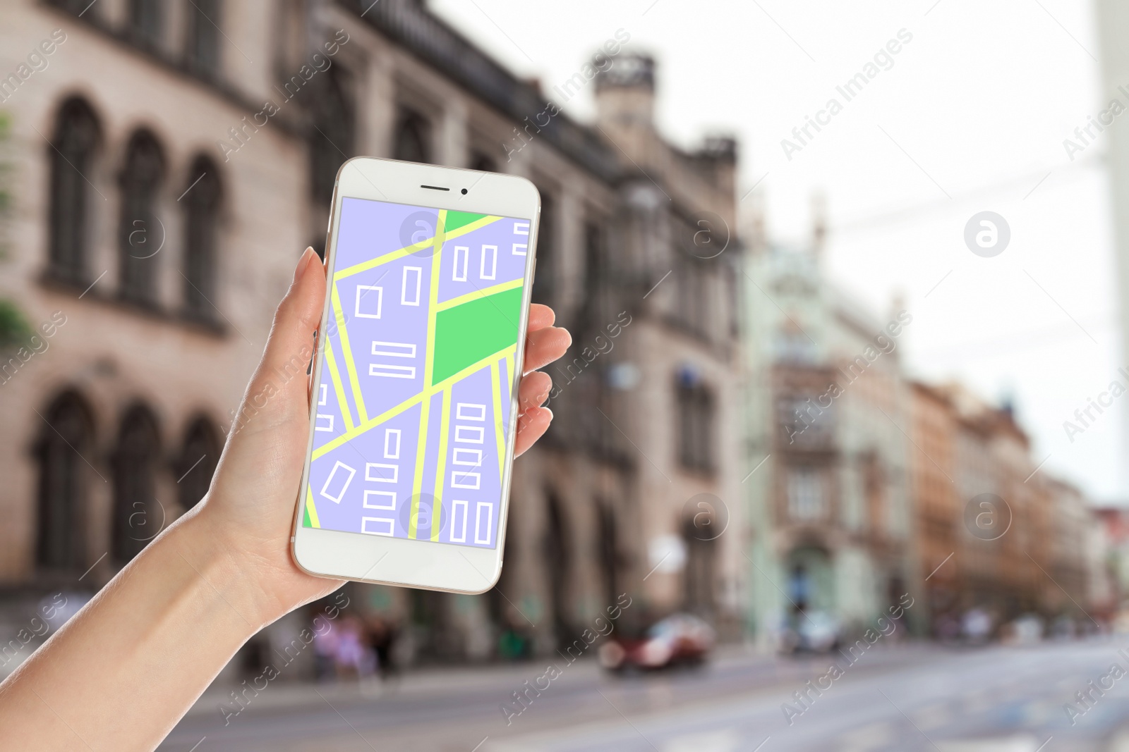 Image of Woman searching location with smartphone in city, closeup. Space for text 