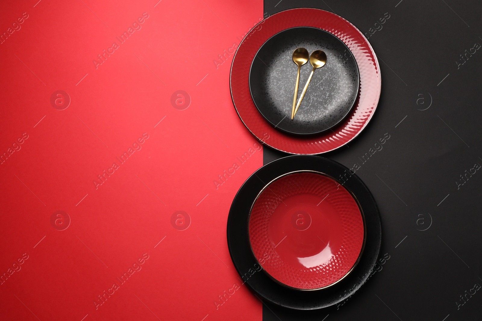 Photo of Stylish table setting with plates and spoons on color background, top view. Space for text