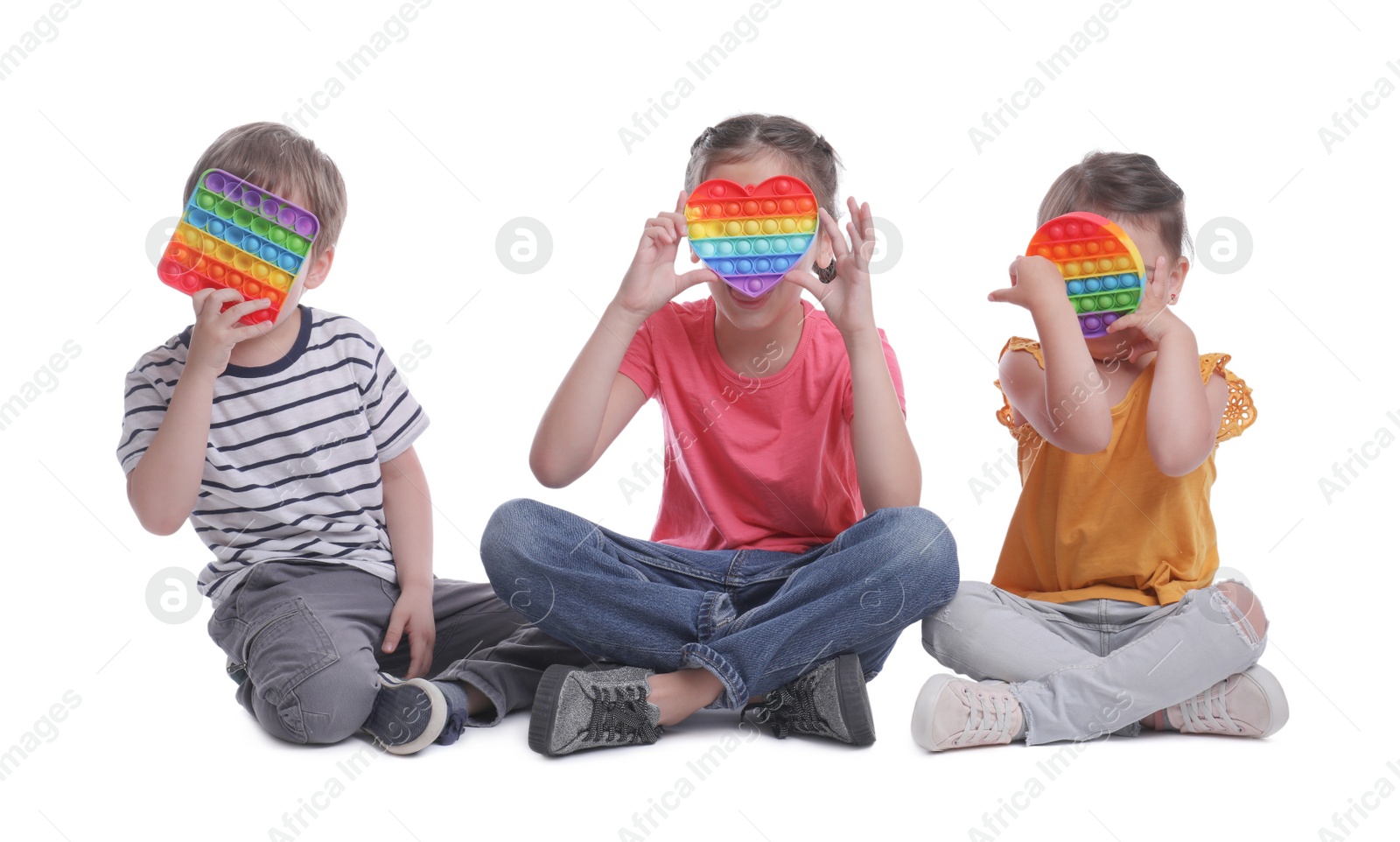 Photo of Little children with pop it fidget toys on white background